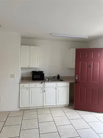 a kitchen with a cabinets and white appliances