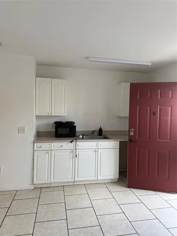 a kitchen with a cabinets and white appliances