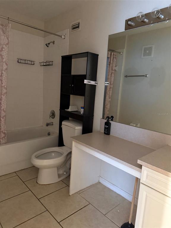 217 Australian Way, Unit 5 Davenport, FL 33897 - Photo 8 of 8 a bathroom with a sink a toilet and shower