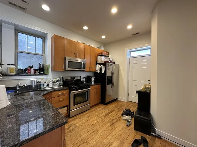 a kitchen with sink refrigerator and microwave