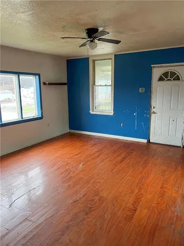 an empty room with windows and closet