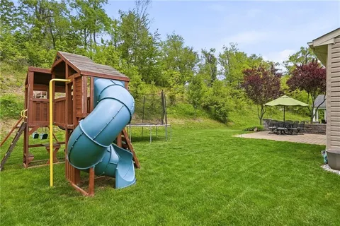 a backyard of a house with table and chairs