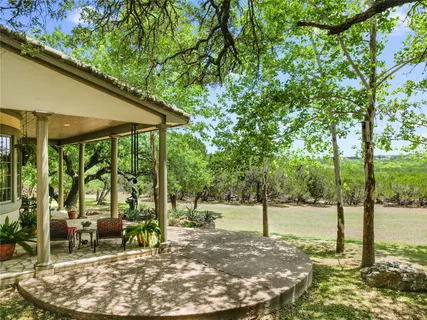 an aerial view of residential houses with outdoor space and trees