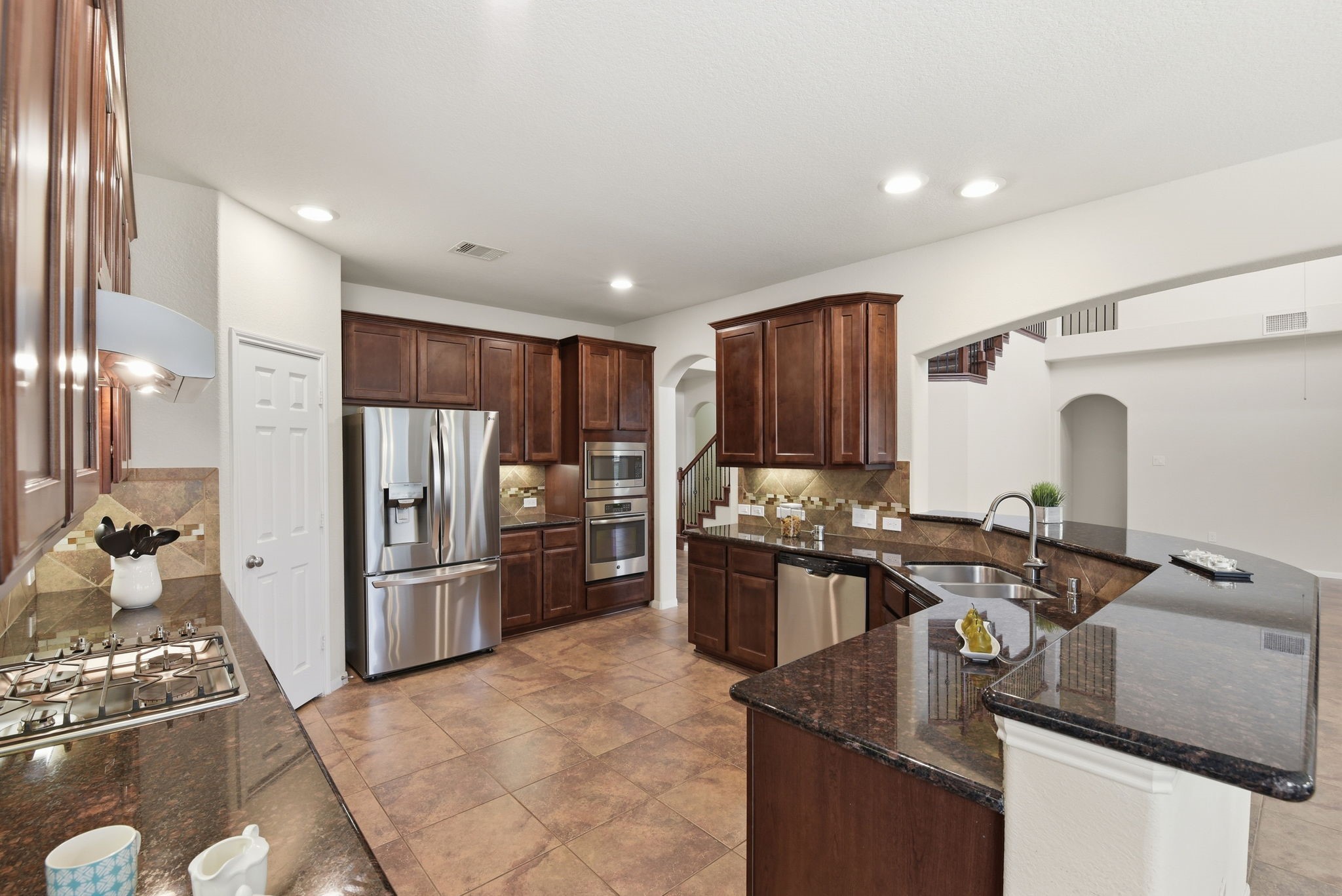3301 Remington Rise Lane Katy, TX 77494 - Photo 10 of 50 a kitchen with stainless steel appliances granite countertop a refrigerator stove and oven