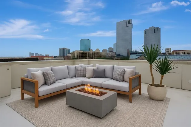 a view of a terrace with couches and sky view