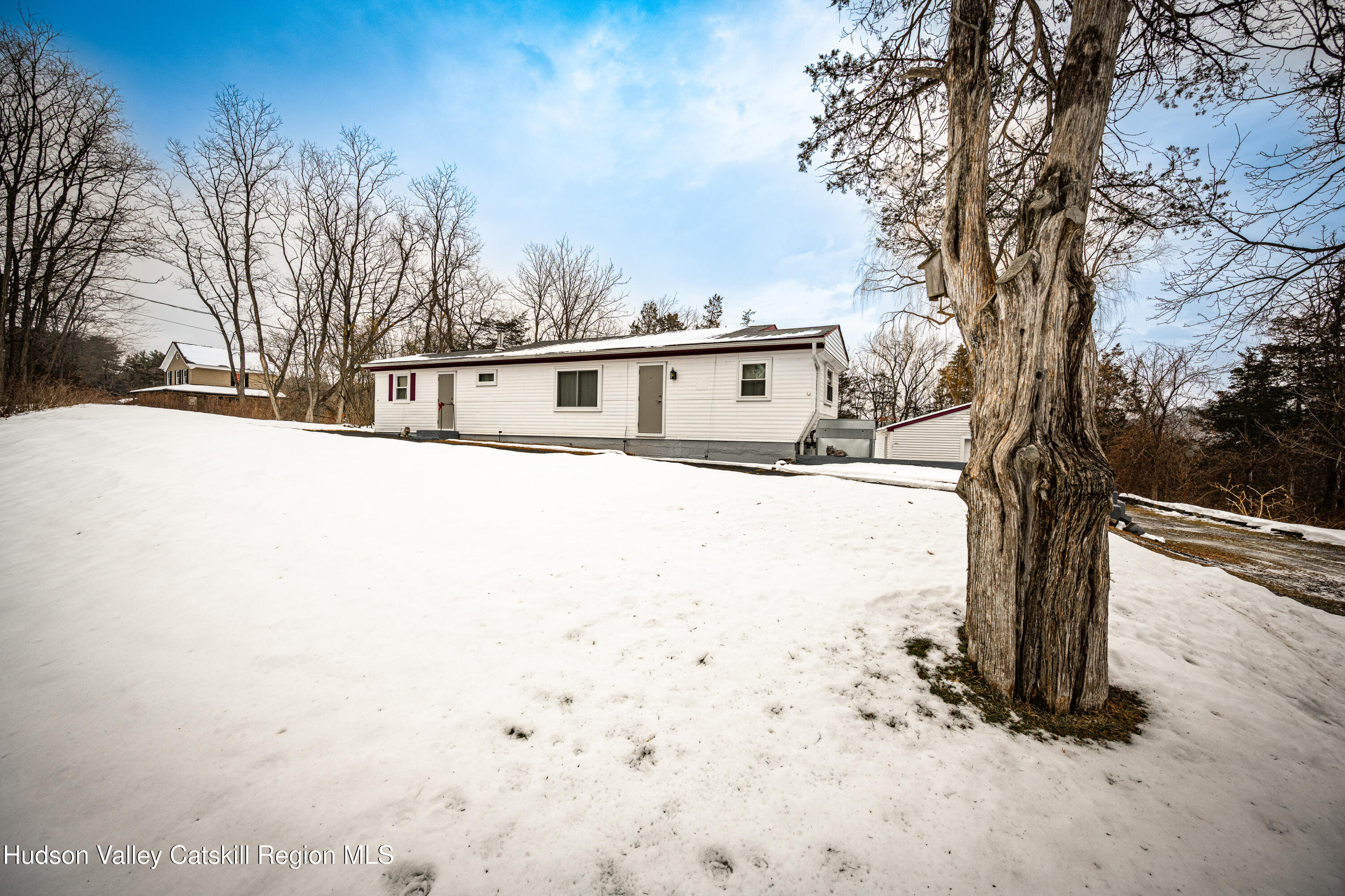 2860 Old Kings Road Catskill, NY 12414 - Photo 3 of 21 a front view of a house with a yard covered in snow
