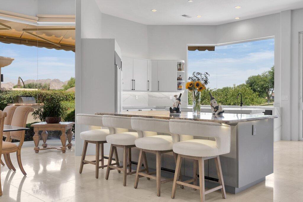 79860 Tangelo La Quinta, CA 92253 - Photo 12 of 45 a dining room with furniture and a large window