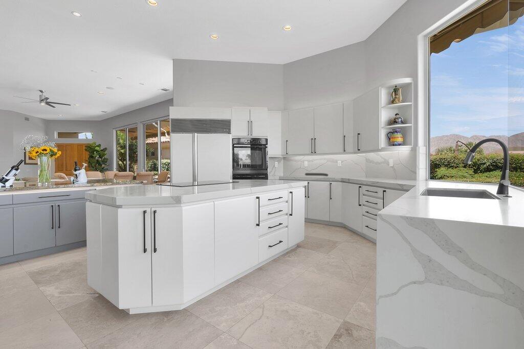 79860 Tangelo La Quinta, CA 92253 - Photo 13 of 45 a kitchen with white cabinets and white appliances