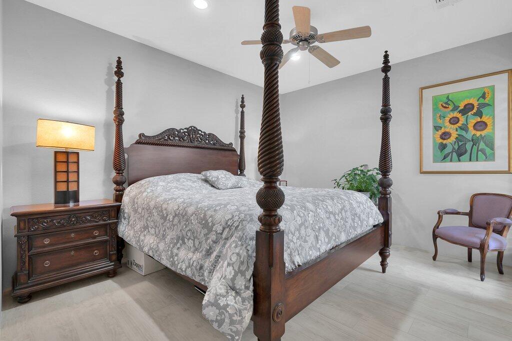 79860 Tangelo La Quinta, CA 92253 - Photo 15 of 45 a bedroom with a bed and dresser with potted plant