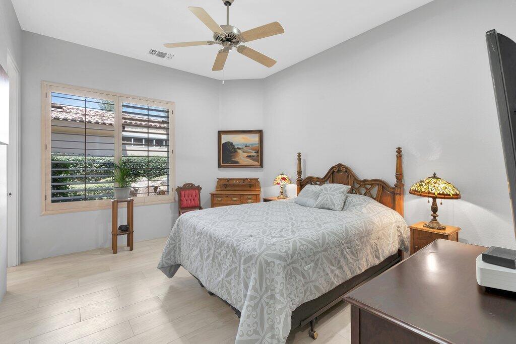 79860 Tangelo La Quinta, CA 92253 - Photo 17 of 45 a bedroom with a large bed and a chandelier