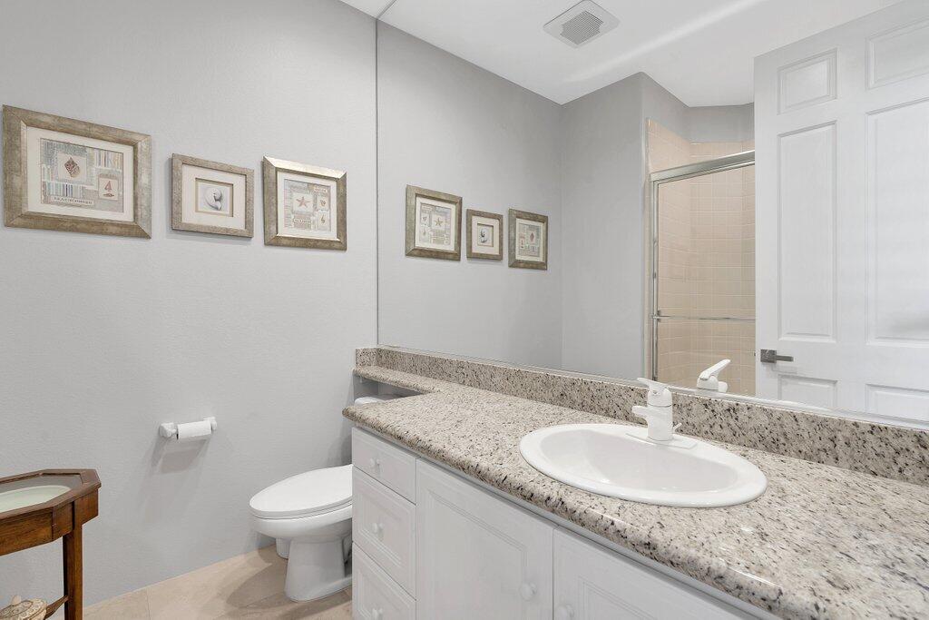 79860 Tangelo La Quinta, CA 92253 - Photo 18 of 45 a bathroom with a granite countertop sink toilet and a mirror