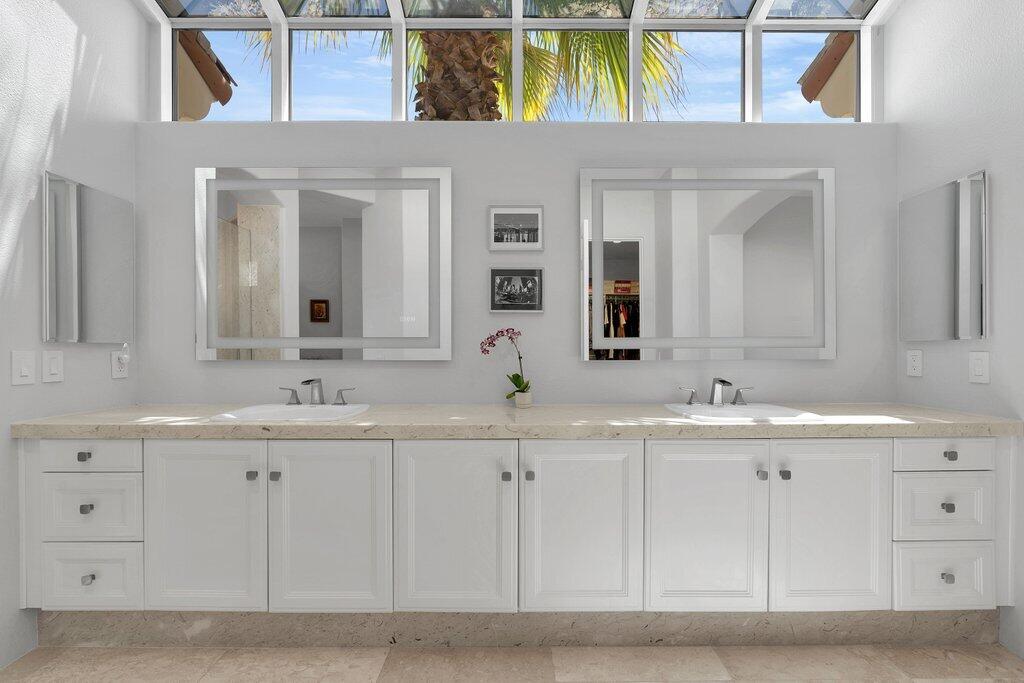 79860 Tangelo La Quinta, CA 92253 - Photo 24 of 45 a bathroom with a granite countertop sink and a mirror