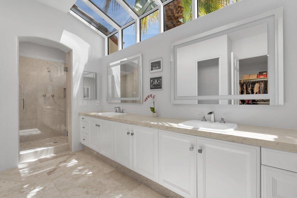 79860 Tangelo La Quinta, CA 92253 - Photo 27 of 45 a bathroom with a granite countertop double vanity sink a mirror and shower