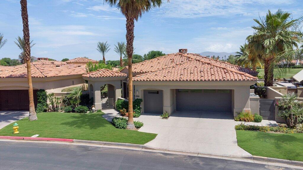 79860 Tangelo La Quinta, CA 92253 - Photo 3 of 45 a front view of a house with a yard and potted plants