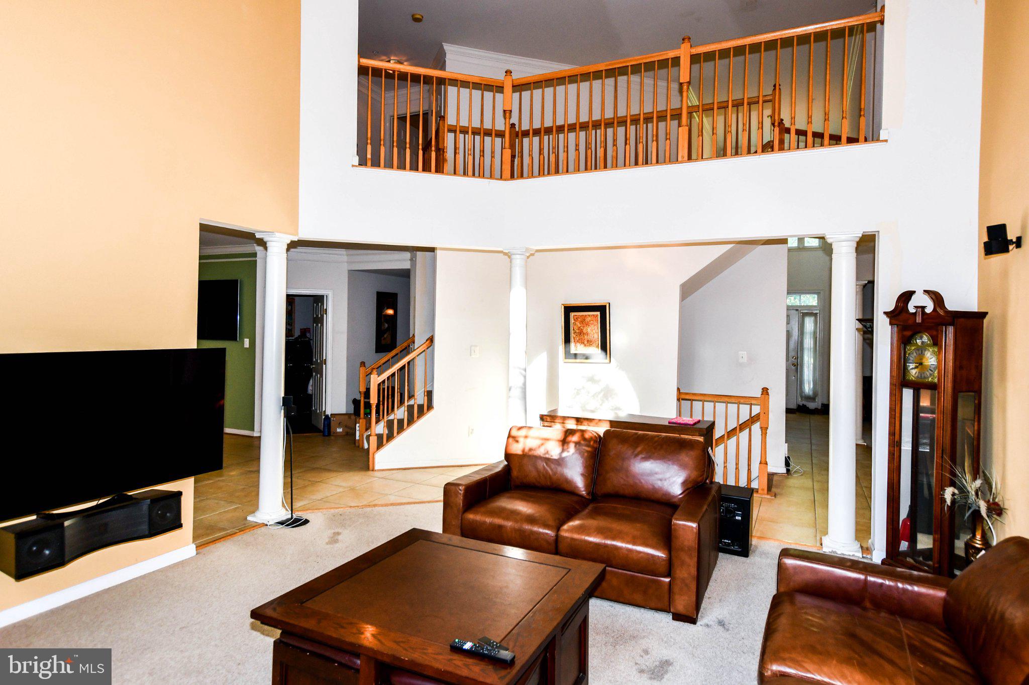 3208 Clavier Place Clinton, MD 20735 - Photo 12 of 55 a living room with furniture a flat screen tv and gym equipment