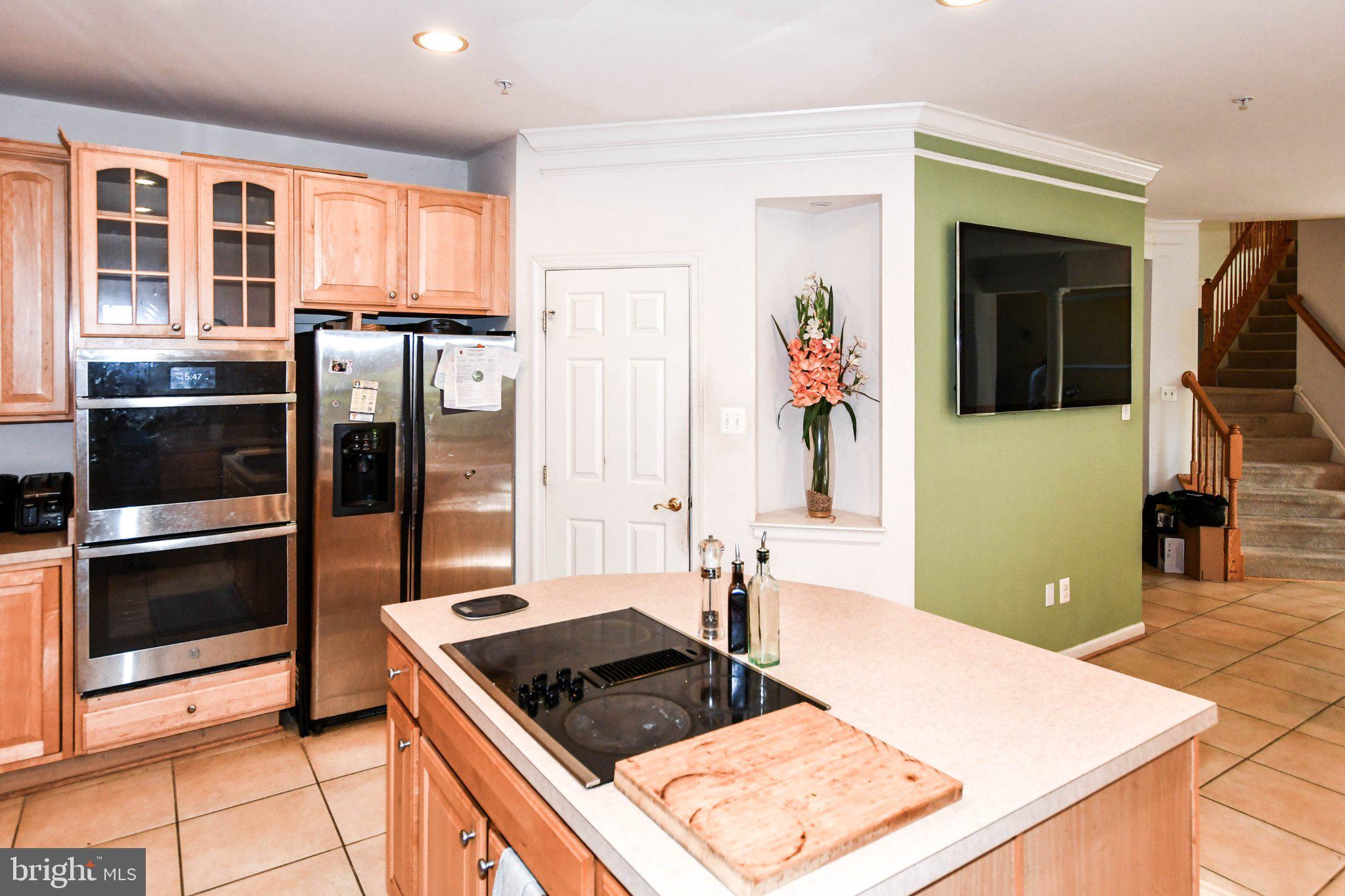 3208 Clavier Place Clinton, MD 20735 - Photo 23 of 55 a kitchen with stainless steel appliances granite countertop a refrigerator and a stove top oven