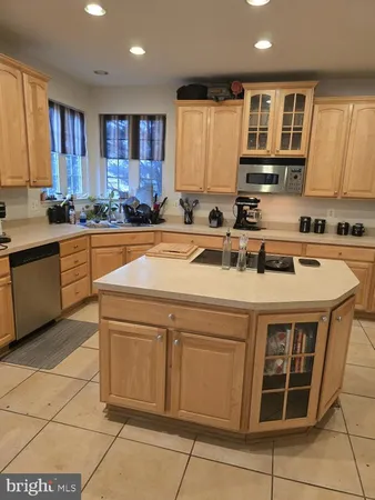 a kitchen with a stove sink and cabinets