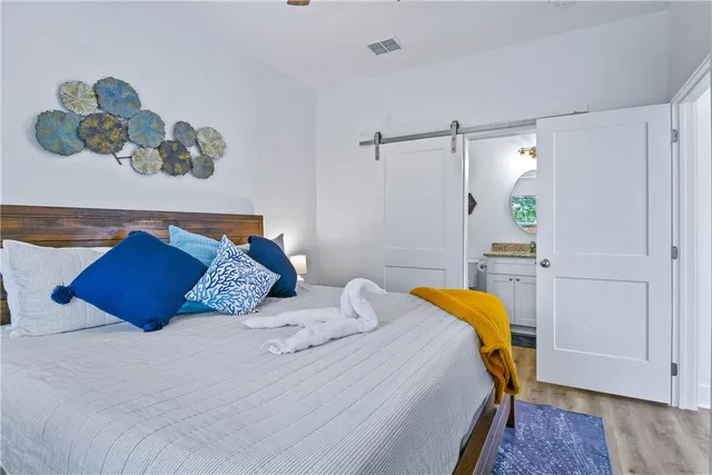 a bedroom with a bed and wooden floor