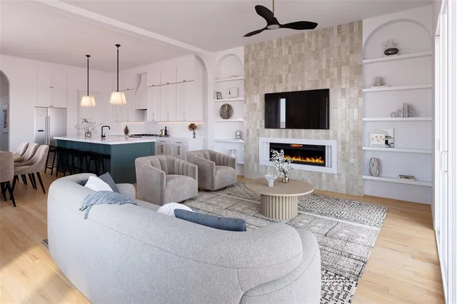 a living room with furniture a flat screen tv and a fireplace