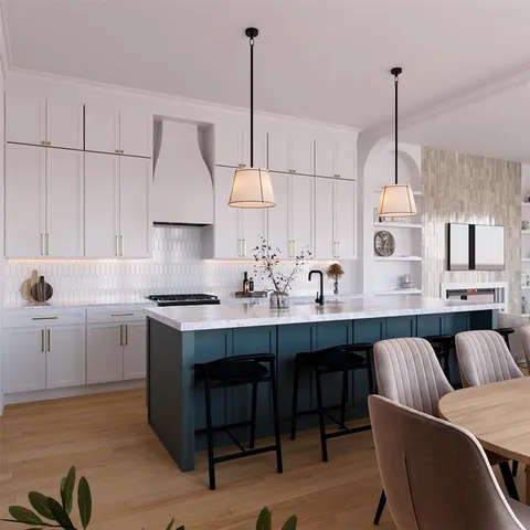 a kitchen with stainless steel appliances granite countertop a sink a stove a dining table and chairs