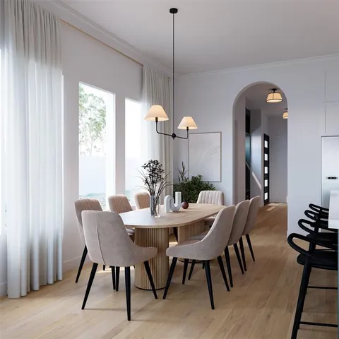 a view of a dining room with furniture and chandelier