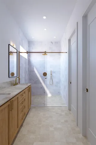 a bathroom with a granite countertop sink mirror and shower