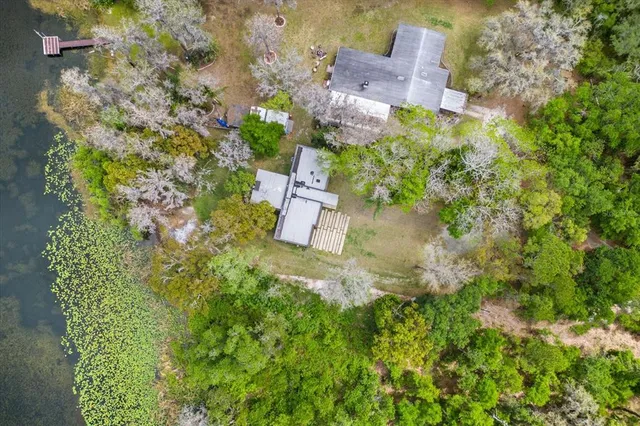 an aerial view of a house with a yard