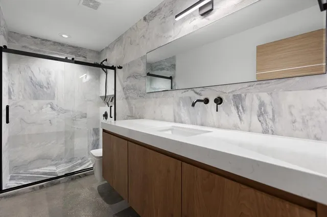 a bathroom with a sink and shower