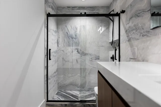 a bathroom with a shower and a sink