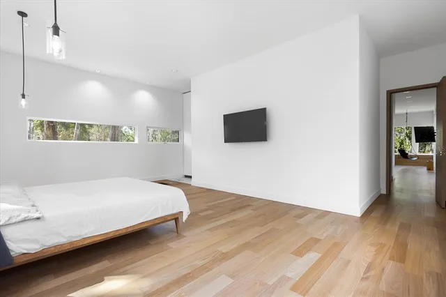 a bedroom with a bed and a flat screen tv