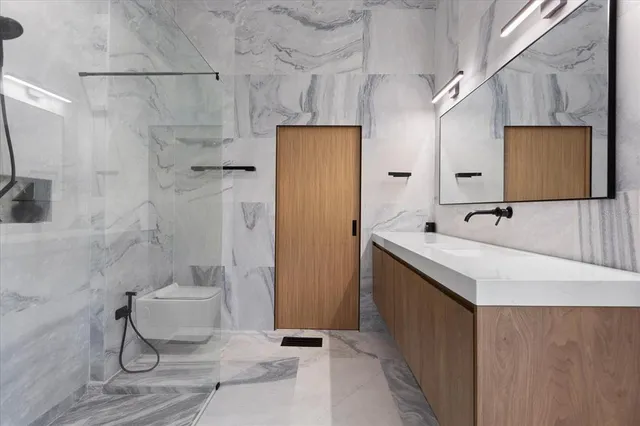 a bathroom with a sink toilet and shower
