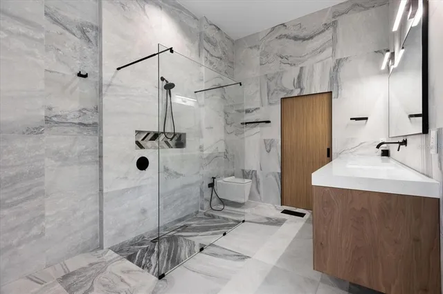 a bathroom with a sink toilet and shower