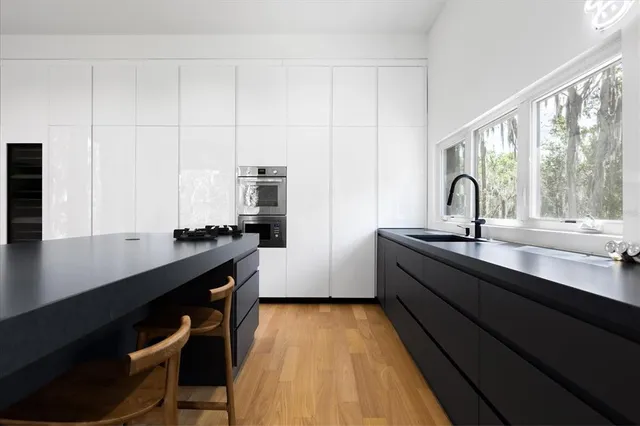 a kitchen with a sink and a stove top oven
