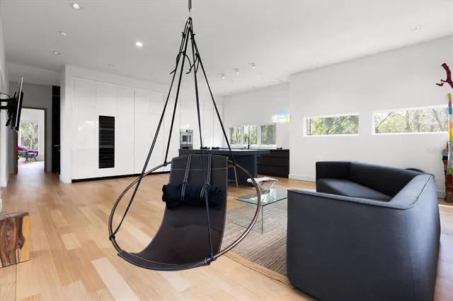 a living room with furniture and a floor to ceiling window
