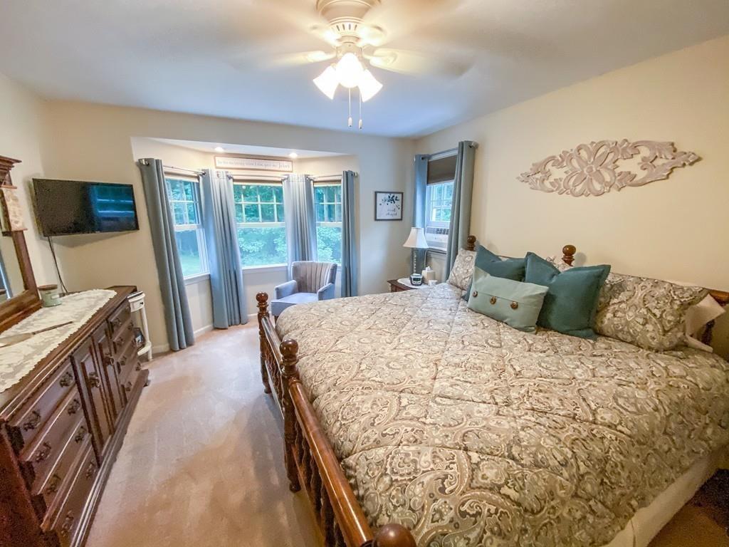 63 Campbell Street Rutland, MA 01543 - Photo 18 of 42 a large bedroom with a bed and flat screen tv