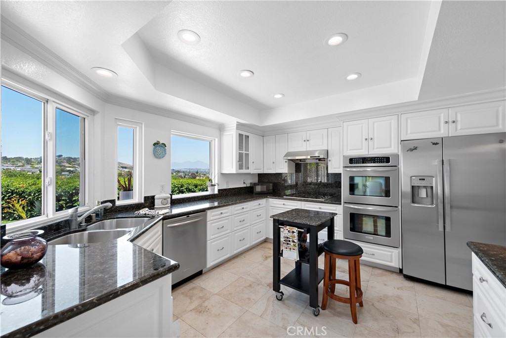 33622 Via Martos Dana Point, CA 92629 - Photo 11 of 46 a kitchen with a sink a counter top stainless steel appliances cabinets and a large window
