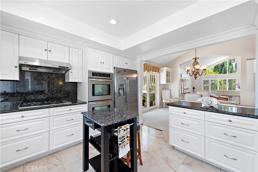 33622 Via Martos Dana Point, CA 92629 - Photo 13 of 46 a kitchen with granite countertop white cabinets and appliances