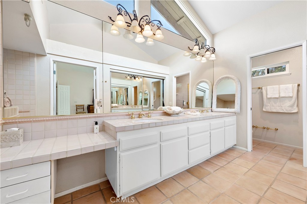 33622 Via Martos Dana Point, CA 92629 - Photo 28 of 46 a spacious bathroom with a granite countertop sink a toilet a mirror and vanity