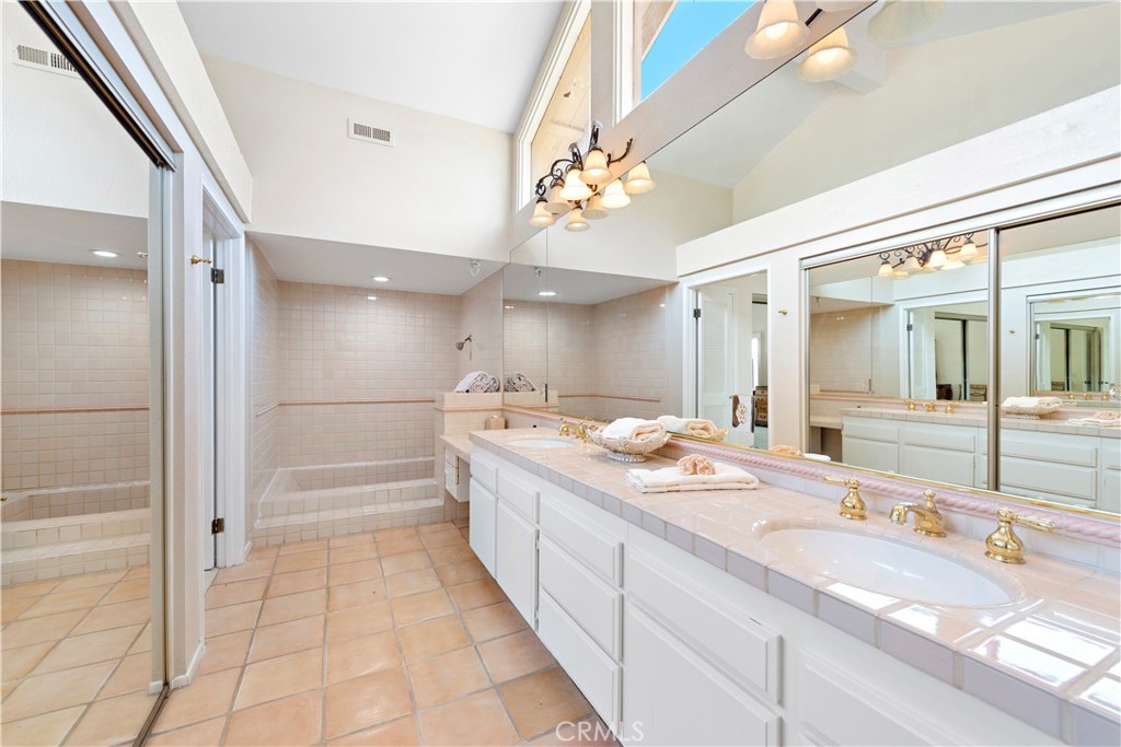 33622 Via Martos Dana Point, CA 92629 - Photo 29 of 46 a bathroom with a granite countertop sink a large mirror and a bathtub
