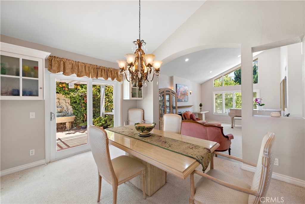33622 Via Martos Dana Point, CA 92629 - Photo 9 of 46 a view of a dining room with furniture a chandelier and large windows