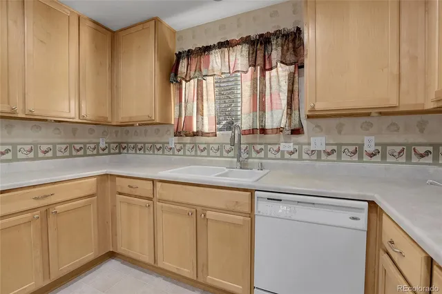 a kitchen with white cabinets and a sink