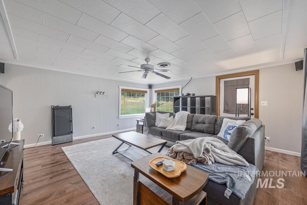 259 Highway 12 Pomeroy, WA 99347 - Photo 16 of 45 Spacious living area featuring wood-finish flooring, white paneling, and a contemporary ceiling fan
