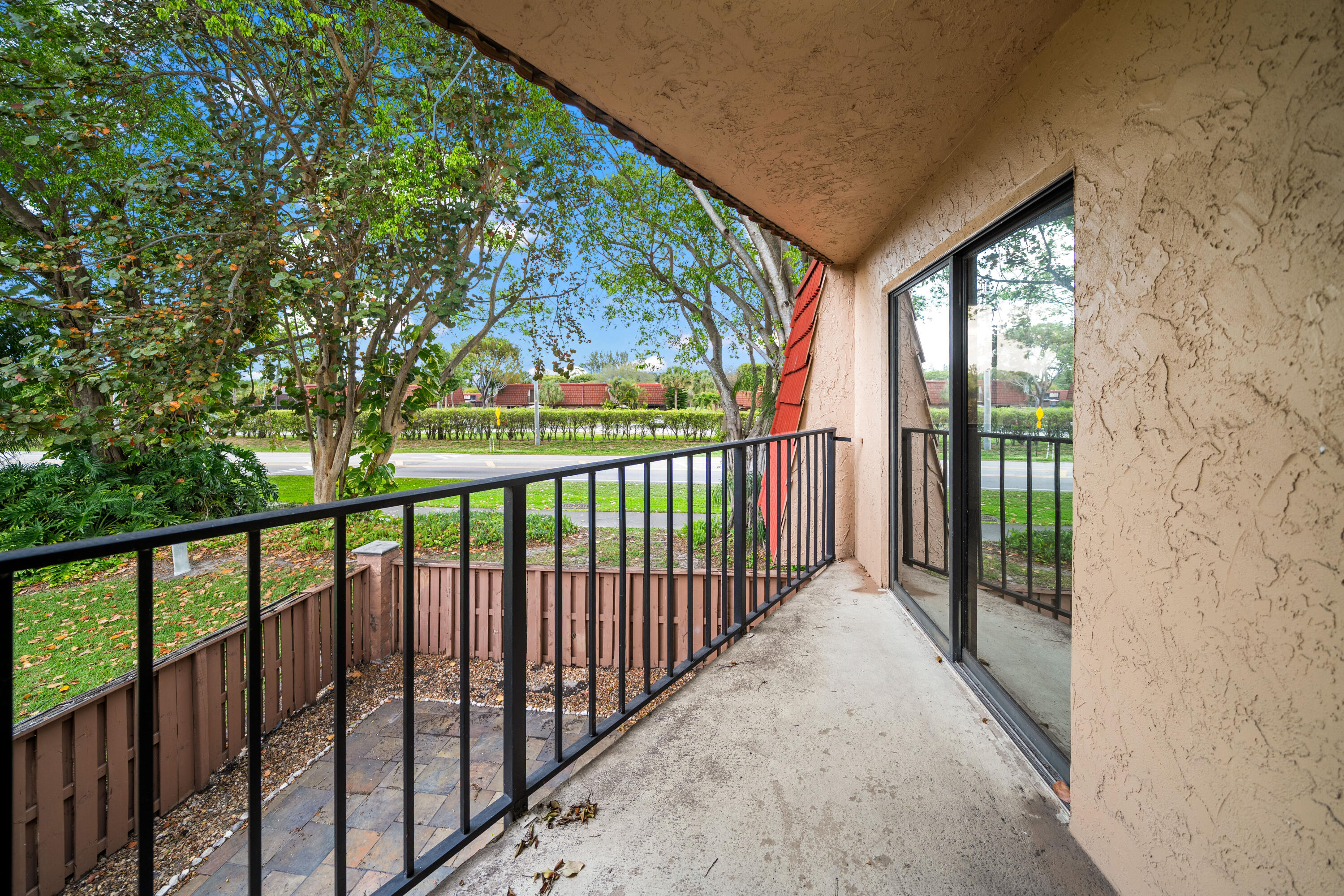 8237 Severn Drive, Unit A Boca Raton, FL 33433 - Photo 15 of 19 a view of a porch and a big yard
