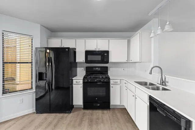 a kitchen with a refrigerator stove and sink