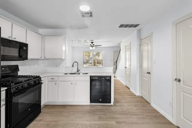a kitchen with a sink stove and microwave