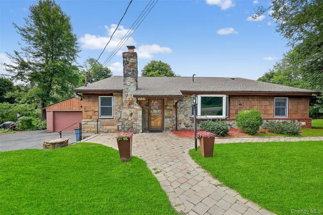 a front view of house with a garden and patio
