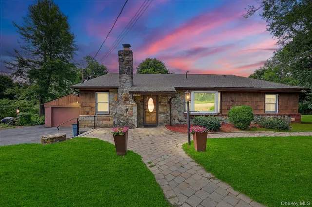 a front view of a house with a yard fire pit and outdoor seating
