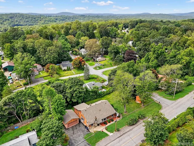 an aerial view of a houses with a yard