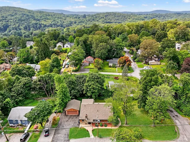 an aerial view of a house with a yard