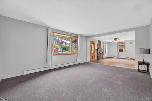 a view of a livingroom with an empty space and a window